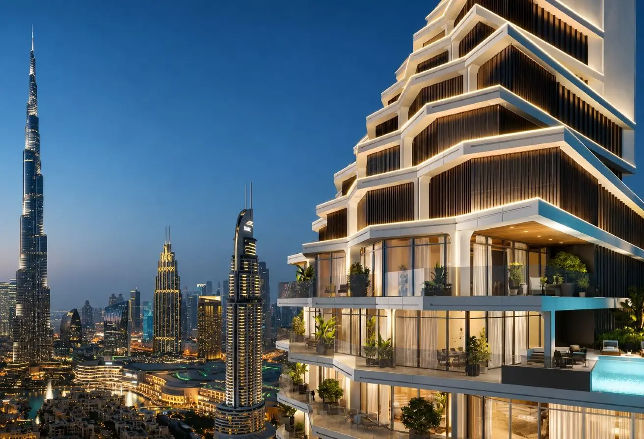 Night view of a modern high-rise with stacked balconies beside a dense city skyline at dusk/night.