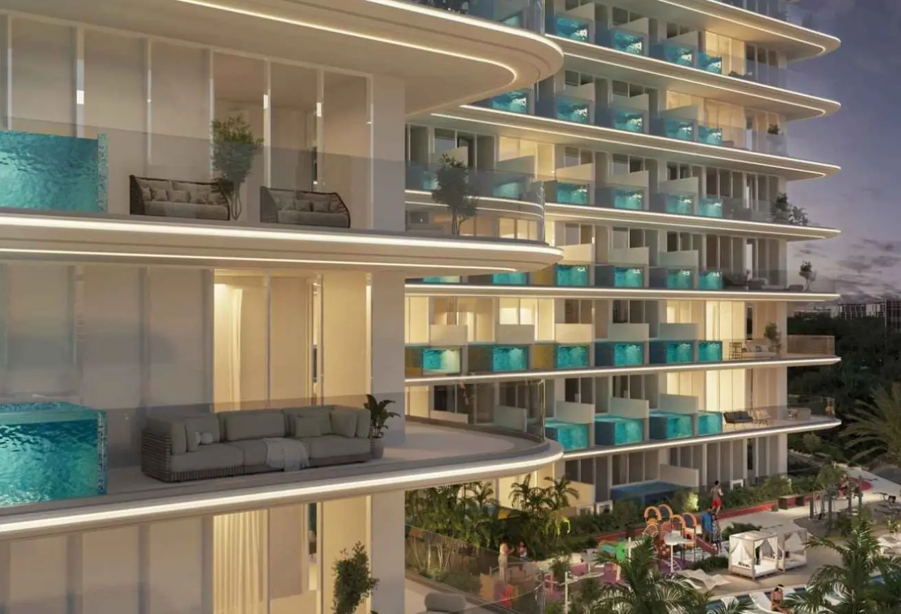 Modern glass-front condo building with curved balconies and turquoise pools on terrace at dusk Coast/landscape setting